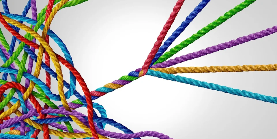 A tangle of string being threaded into a cord