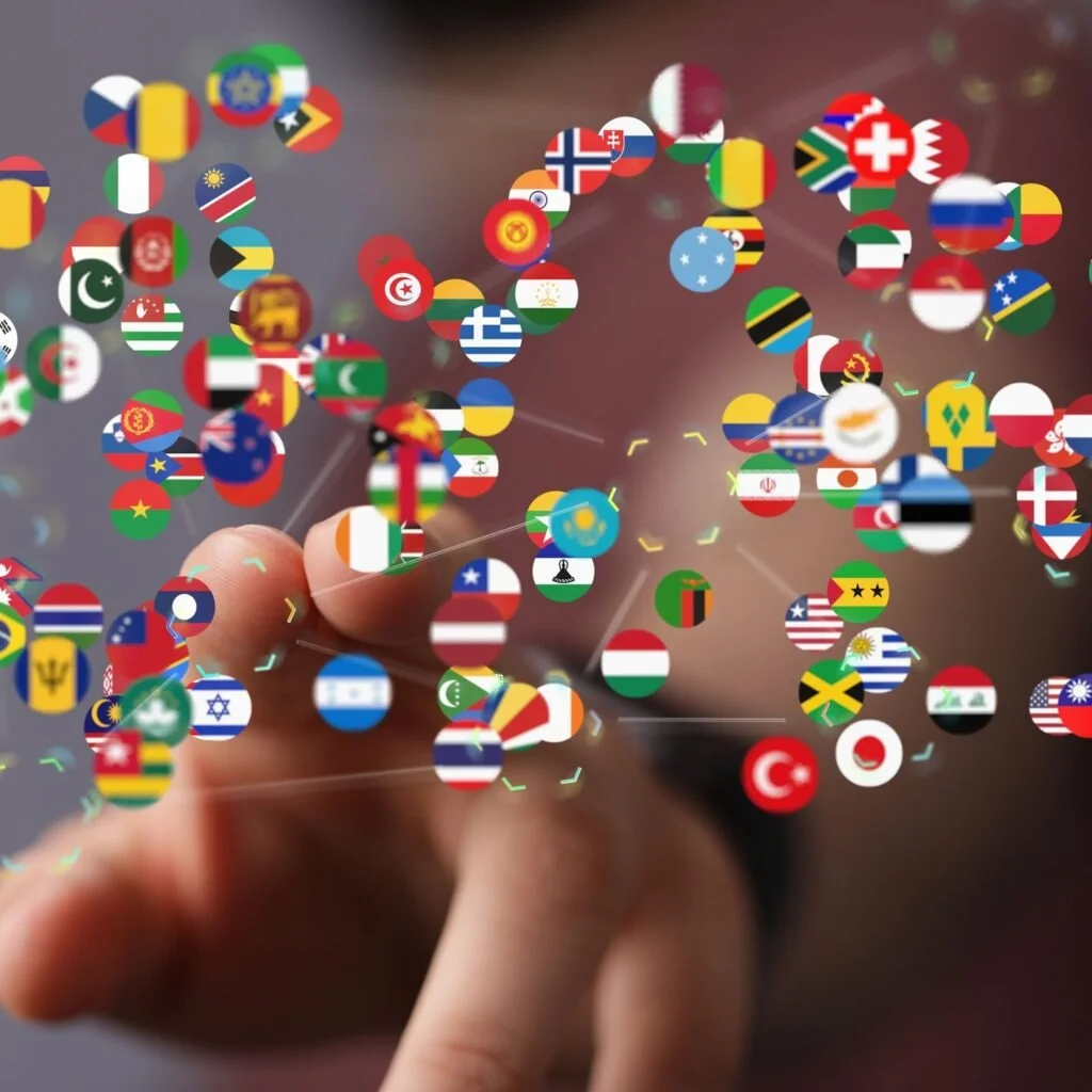 A hand touching visual representations of country flags