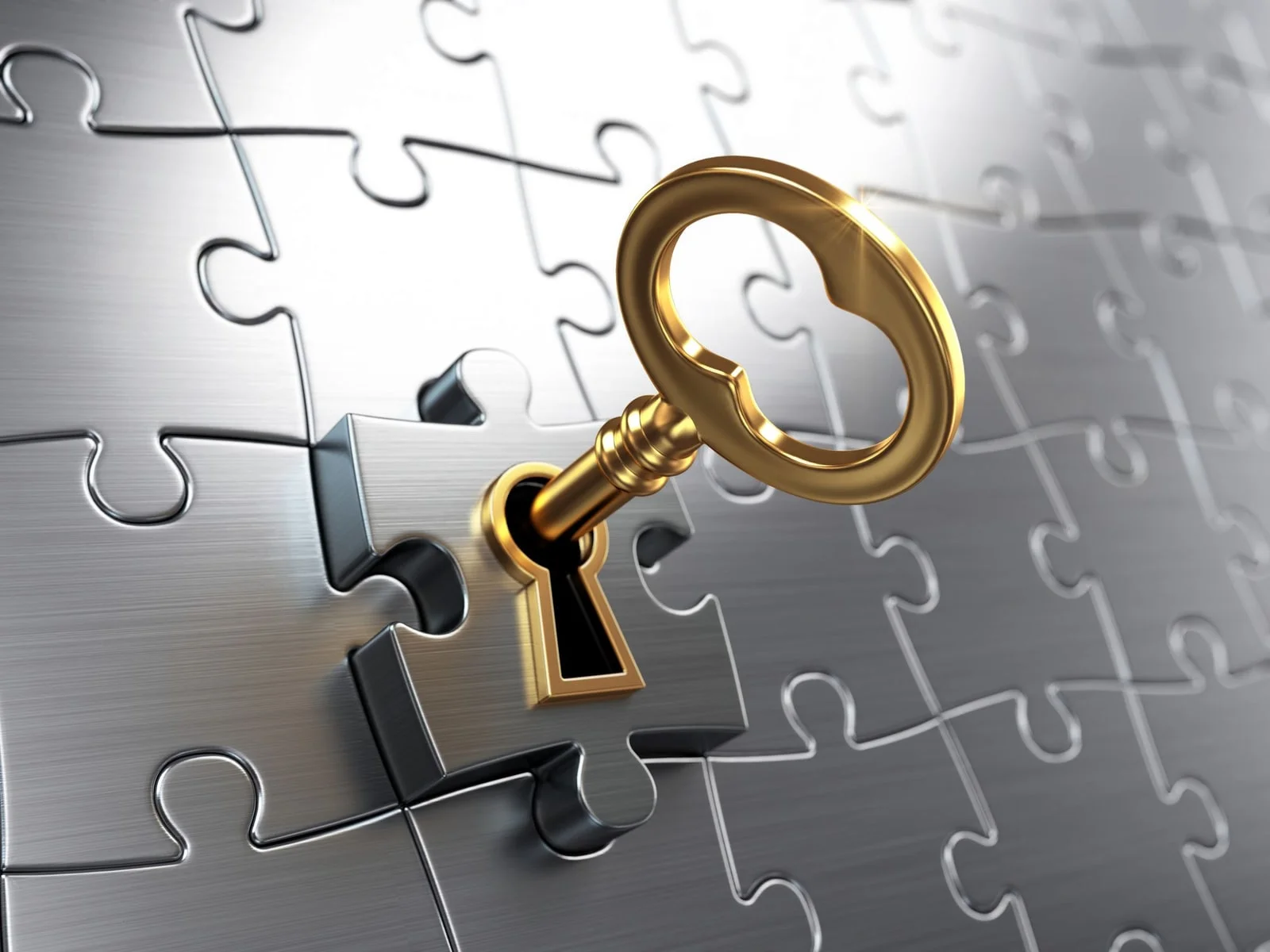A key opening a lockbock of jigsaw puzzles